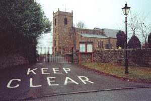 Photo of a church with a big keep clear notice